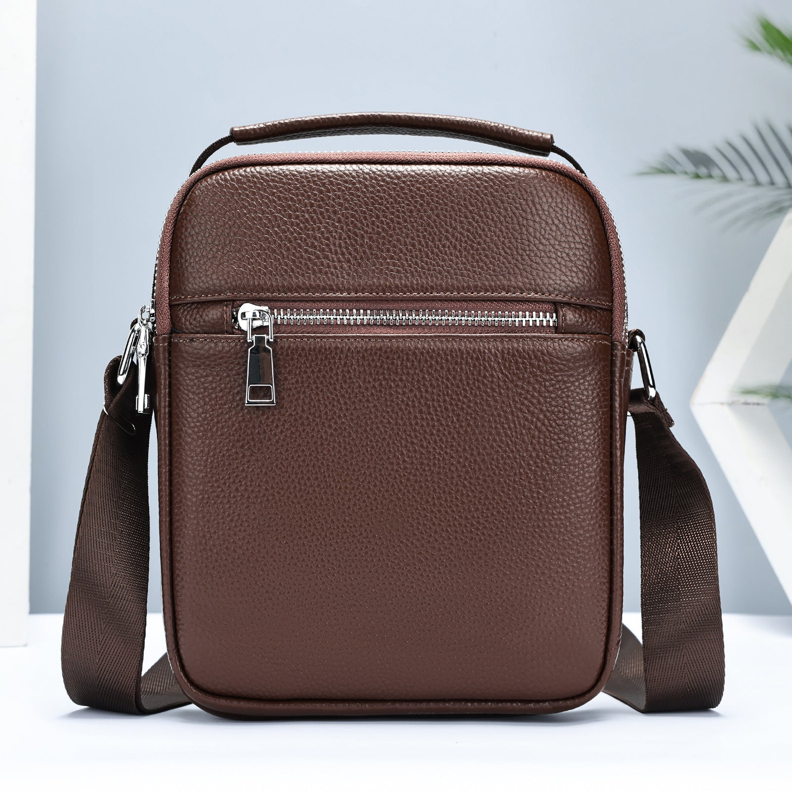 Golden Heir men's cowhide crossbody bag with adjustable strap and multiple compartments, showcasing durable leather construction.