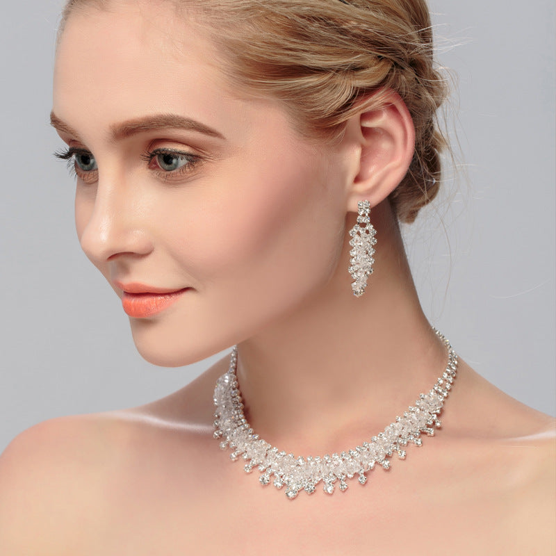 Golden Heir wedding jewelry set with matching earrings and necklace featuring intricate gold designs and sparkling accents.