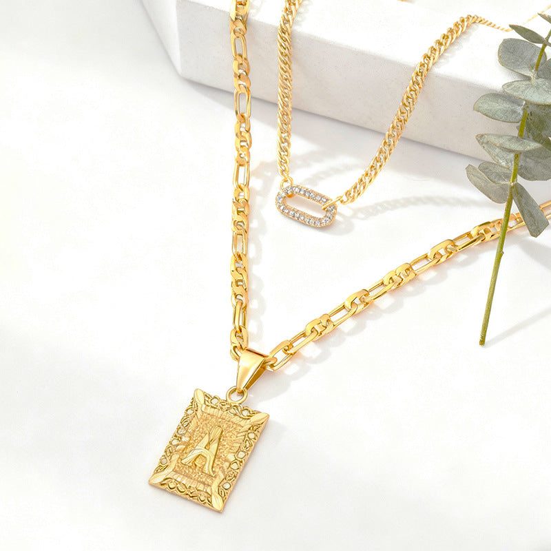 Gold double-layer necklace with 26-letter charms and zircon circle accents, featuring a stylish jewelry design by Golden Heir.