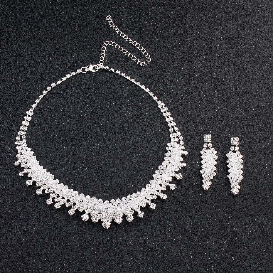 Golden Heir wedding jewelry set with matching necklace and earrings, featuring elegant design and sparkling gemstones.